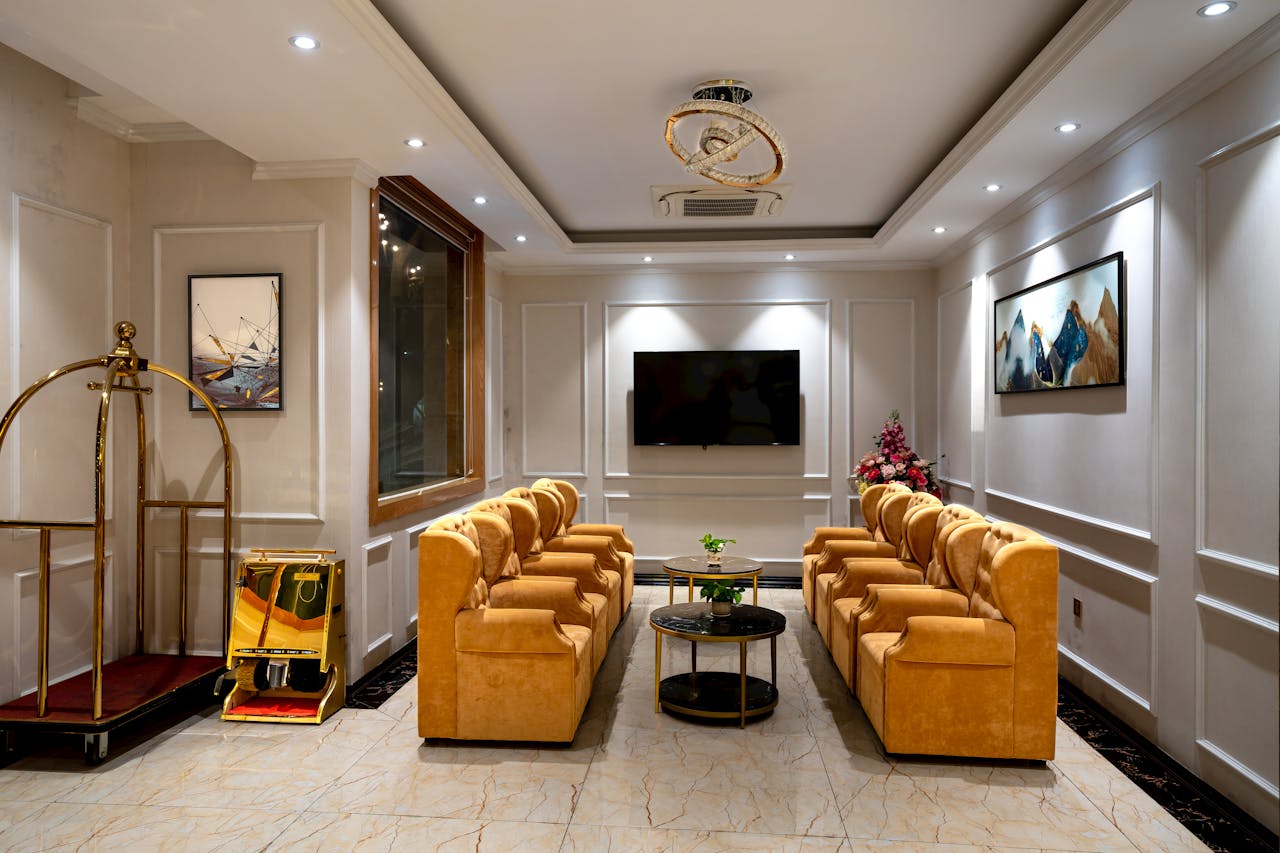 Luxurious hotel lobby featuring stylish armchairs, lighting, and decor.